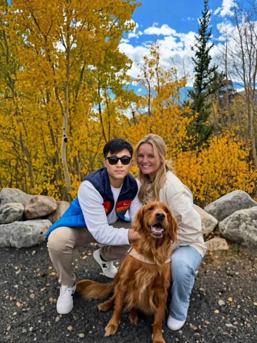 Josh with a golden retriever among yellow aspens